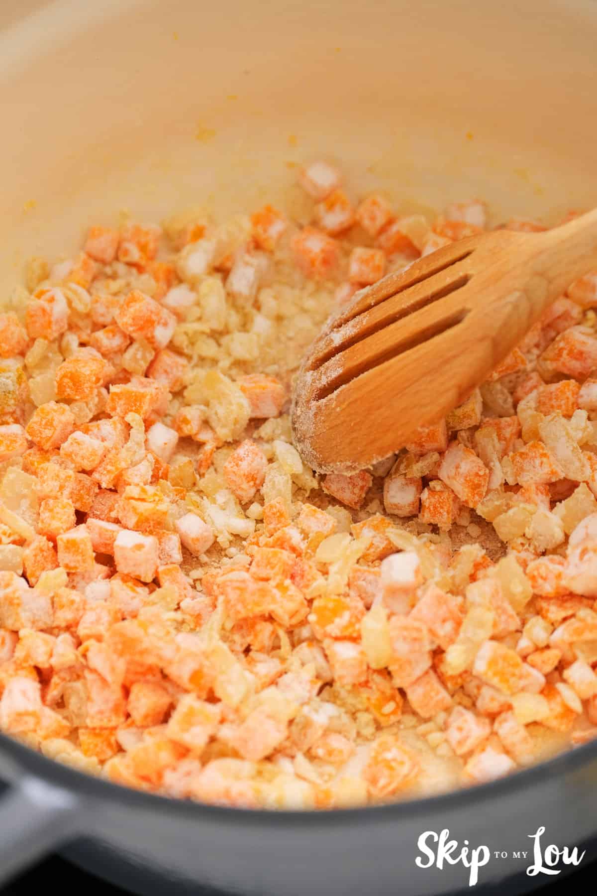 cooking pot with broth, carrots, onions, and flour