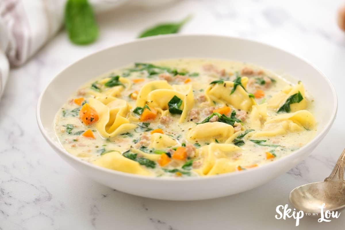 sausage tortellini soup in white bowl
