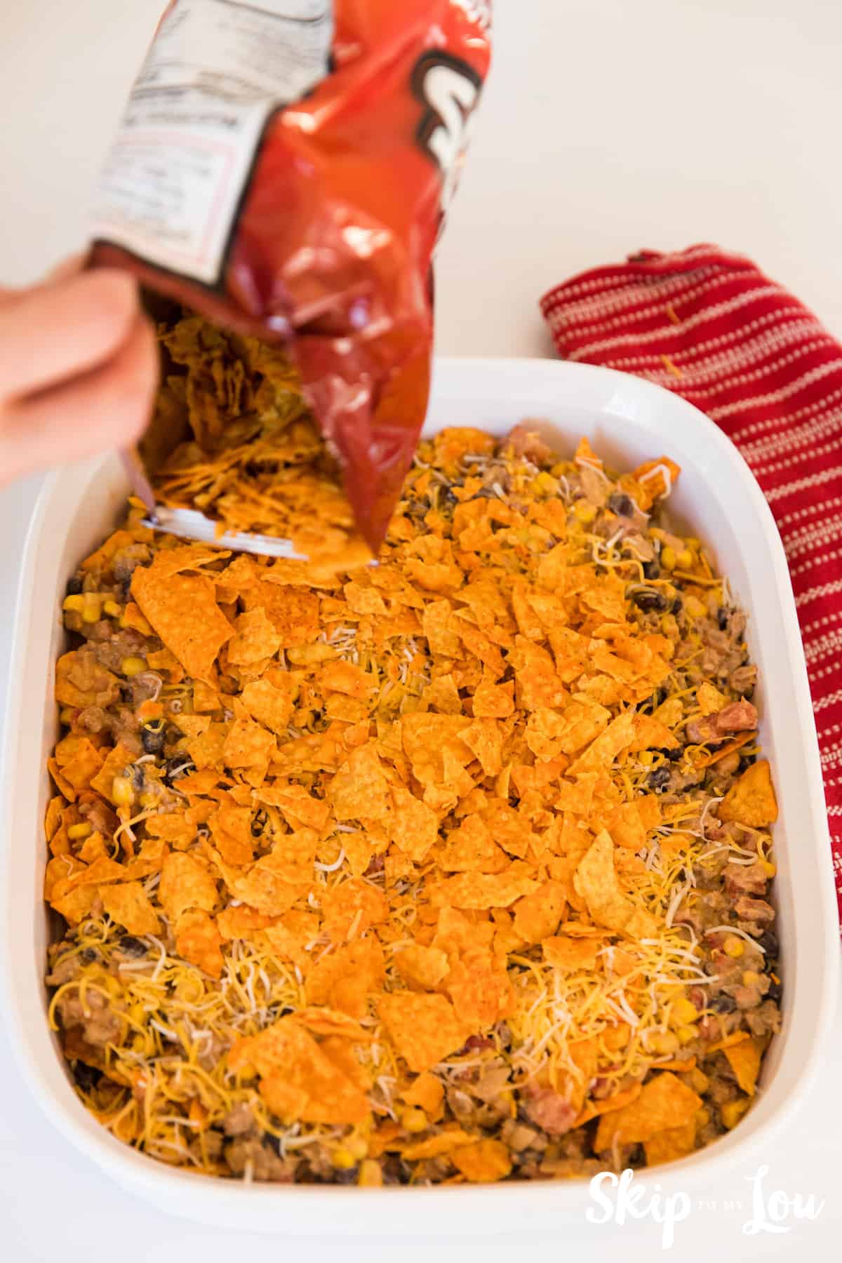 placing doritos on top of Mexican casserole