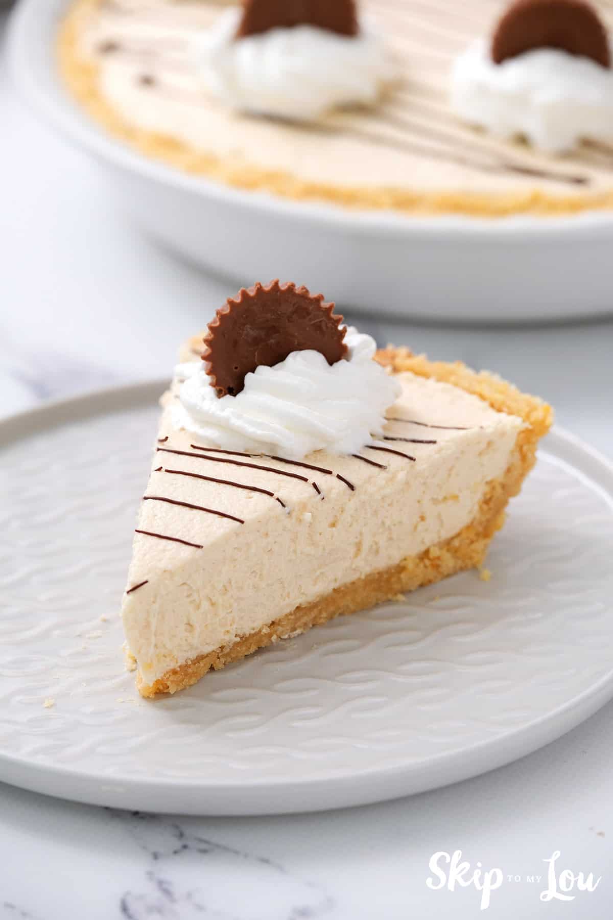 Slice of no bake peanut butter pie on white plate. -Skip To My Lou