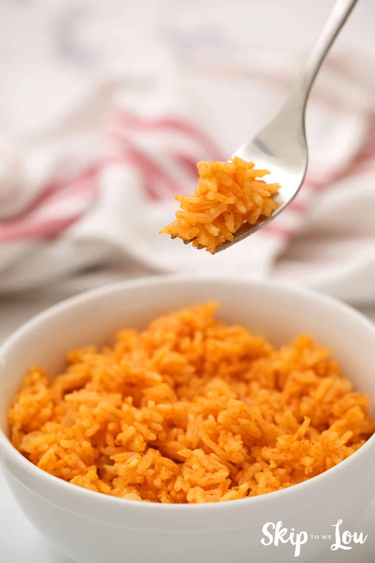 instant pot mexican rice in white bowl with fork full of rice