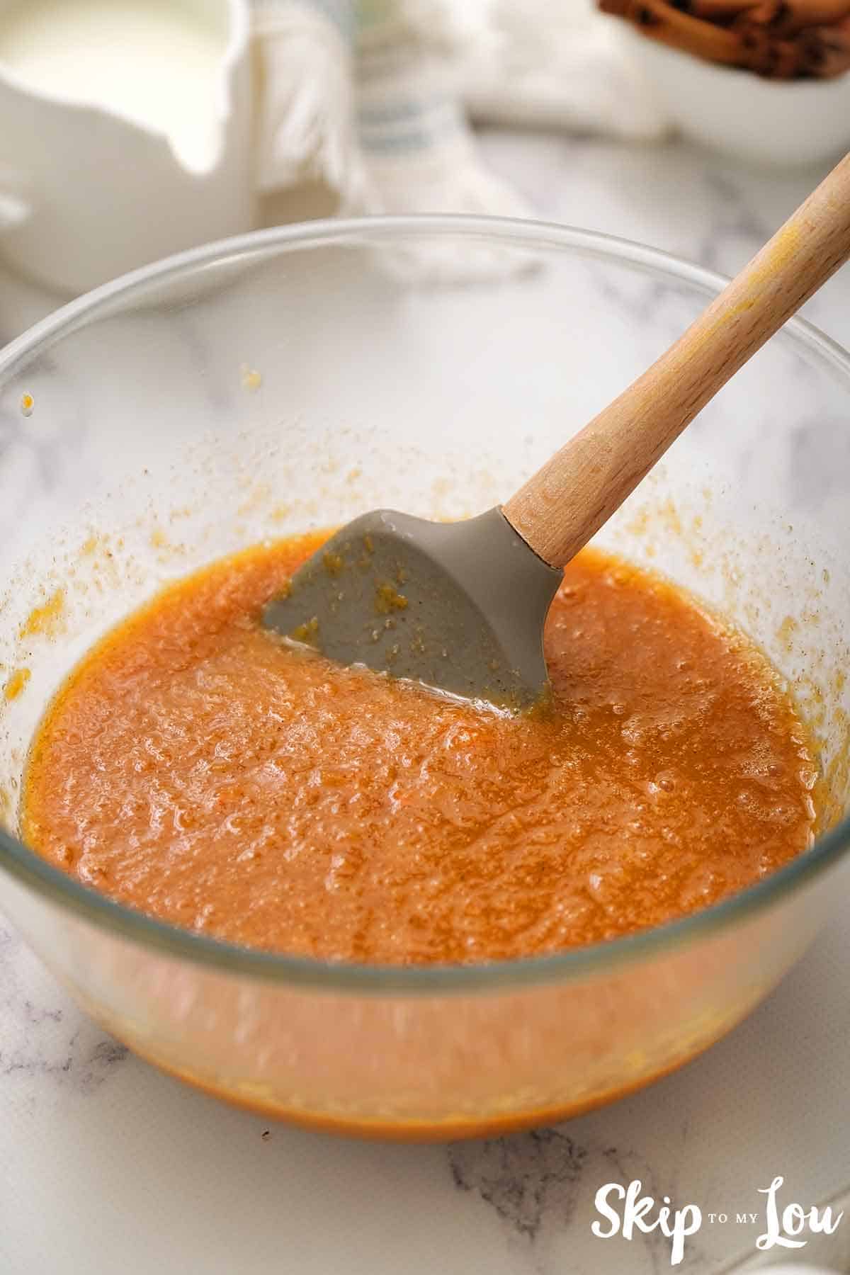 pumpkin pie filling in a bowl with spatula