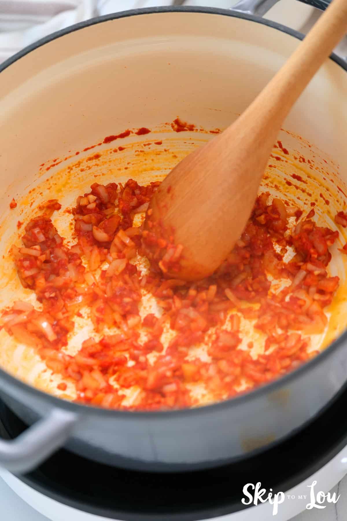 one pot creamy pasta first step cooking onions, garlic, and tomato sauce