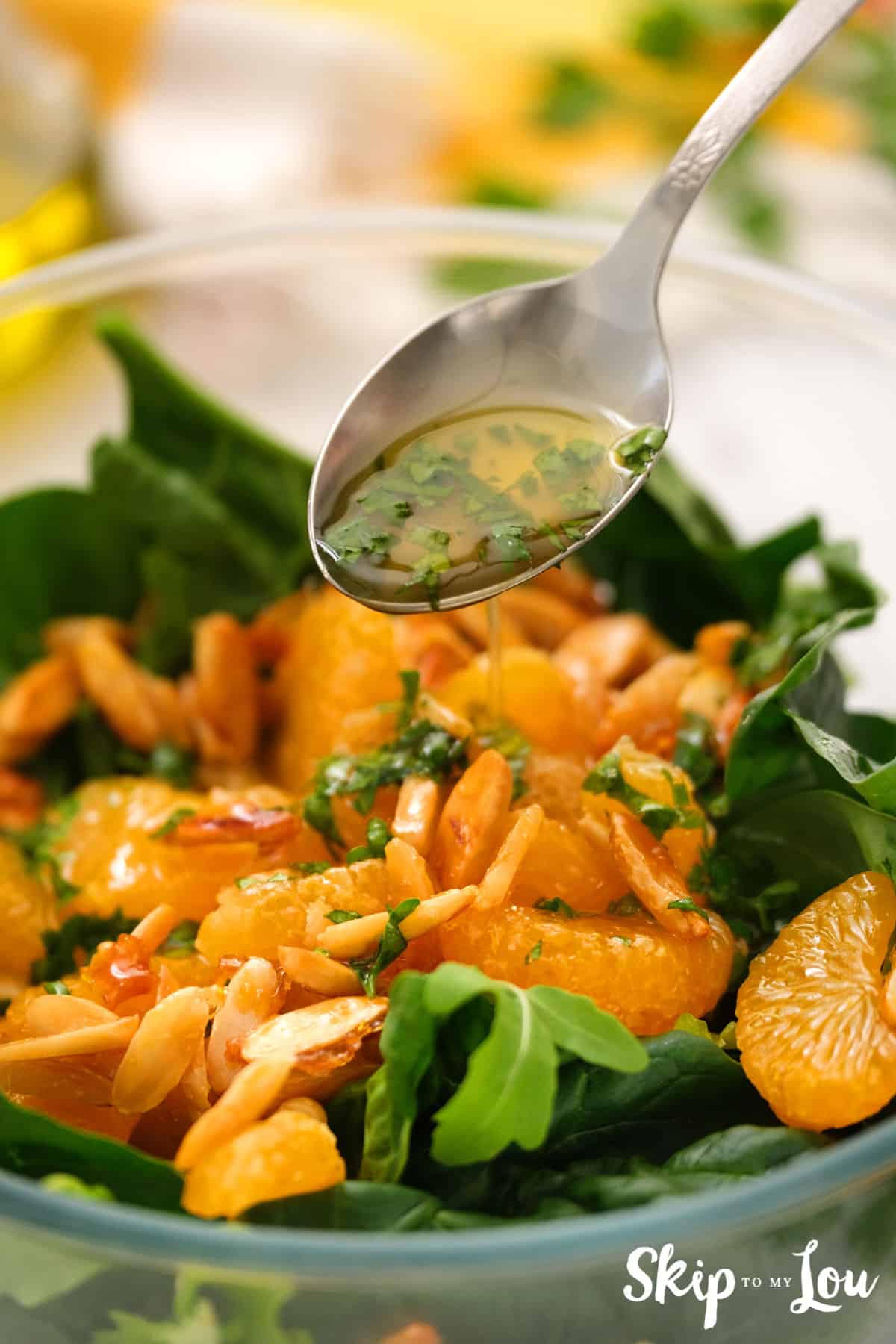 adding dressing to mandarin orange salad