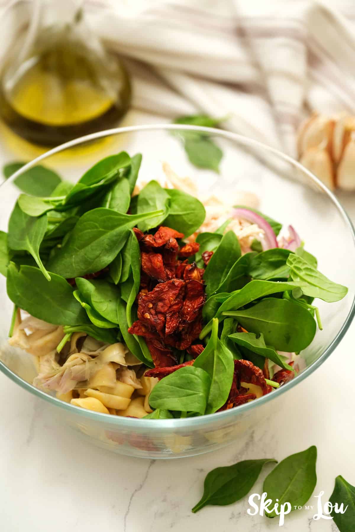 how to make tortellini salad add salad ingredients to a bowl