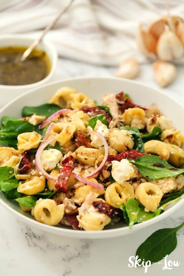 tortellini salad served in a white bowl