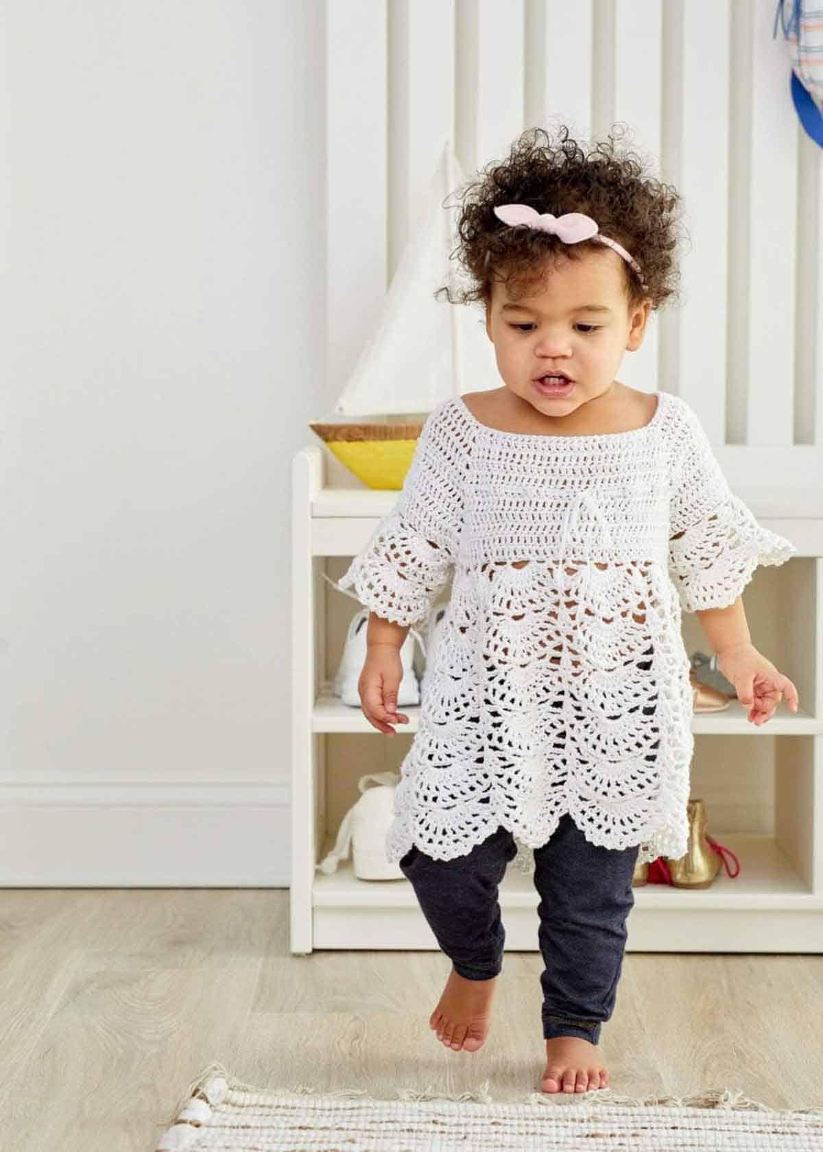 Image shows a white Boho Baby Lace Dress on toddler. -Skip To My Lou