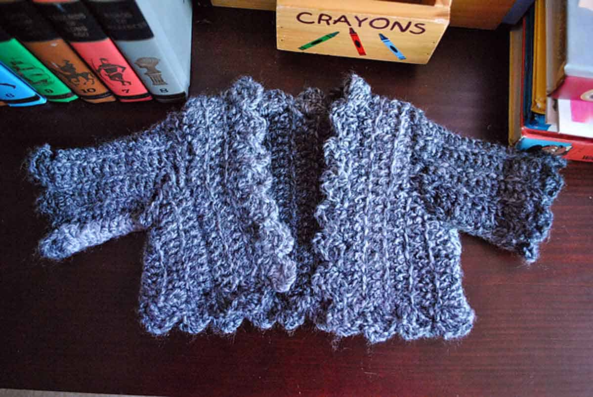Image shows a baby cardigan crochet sweater. -Skip To My Lou
