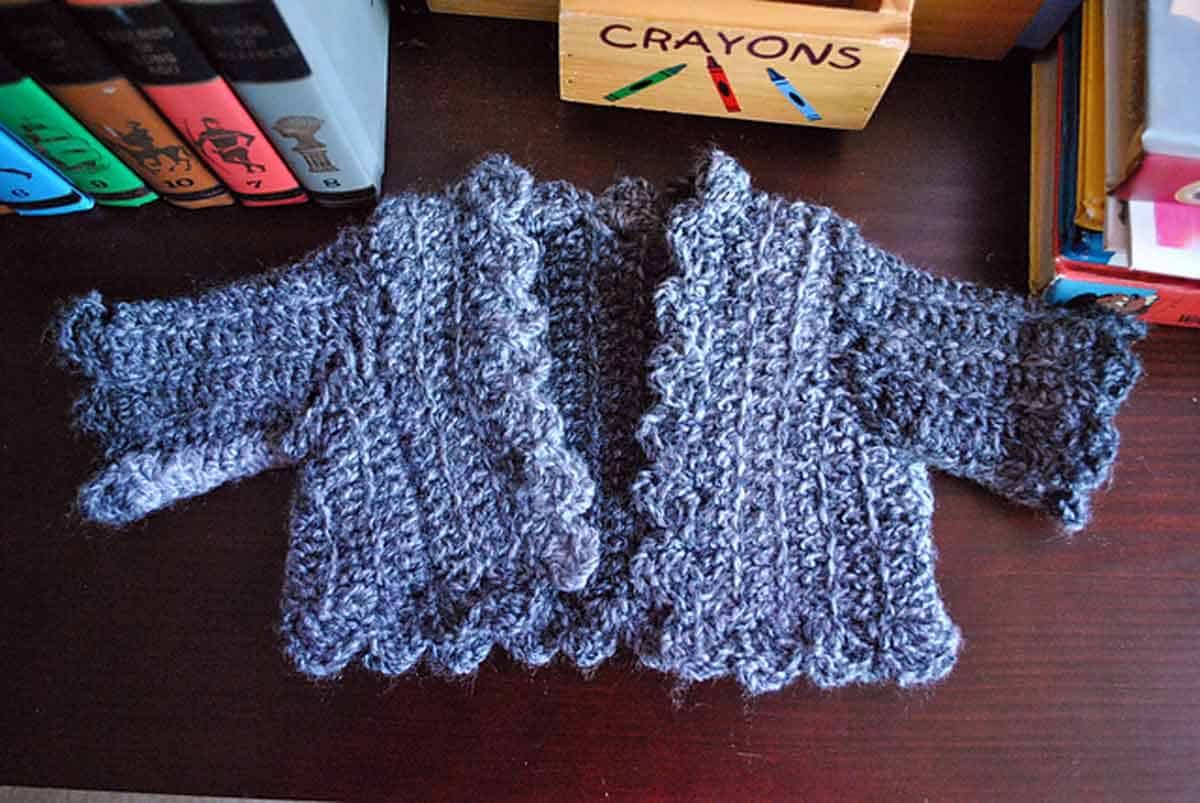 Image shows a baby cardigan crochet sweater. -Skip To My Lou