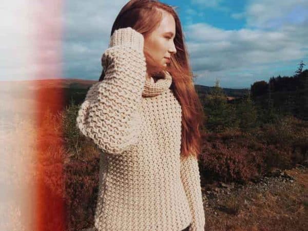 Image shows a chunky cowl sweater on woman. -Skip To My Lou