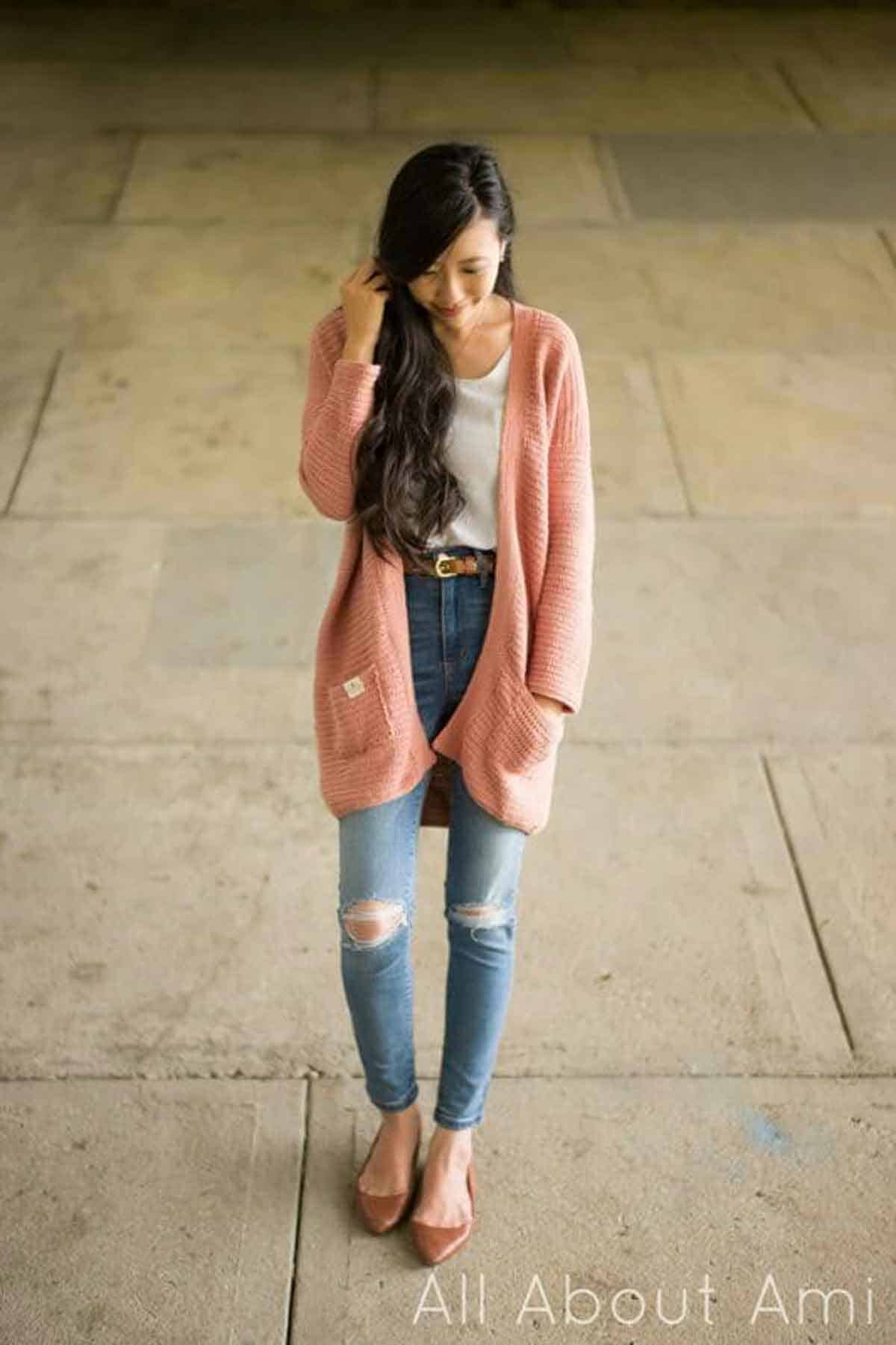 All About Ami Image shows a pink crochet cardigan on woman. -Skip To My Lou
