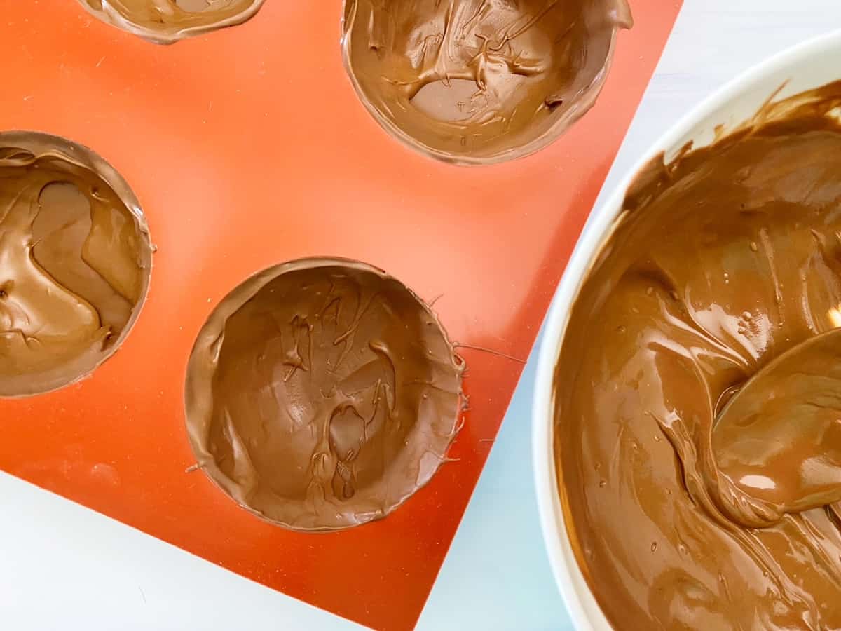 melted chocolate in cocoa bomb mold
