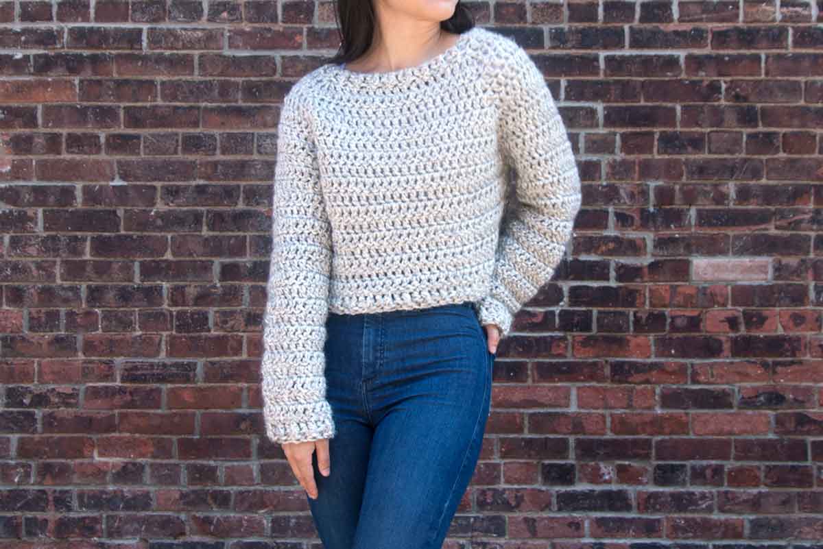 Image shows a girl wearing top down crochet sweater. Skip To My Lou
