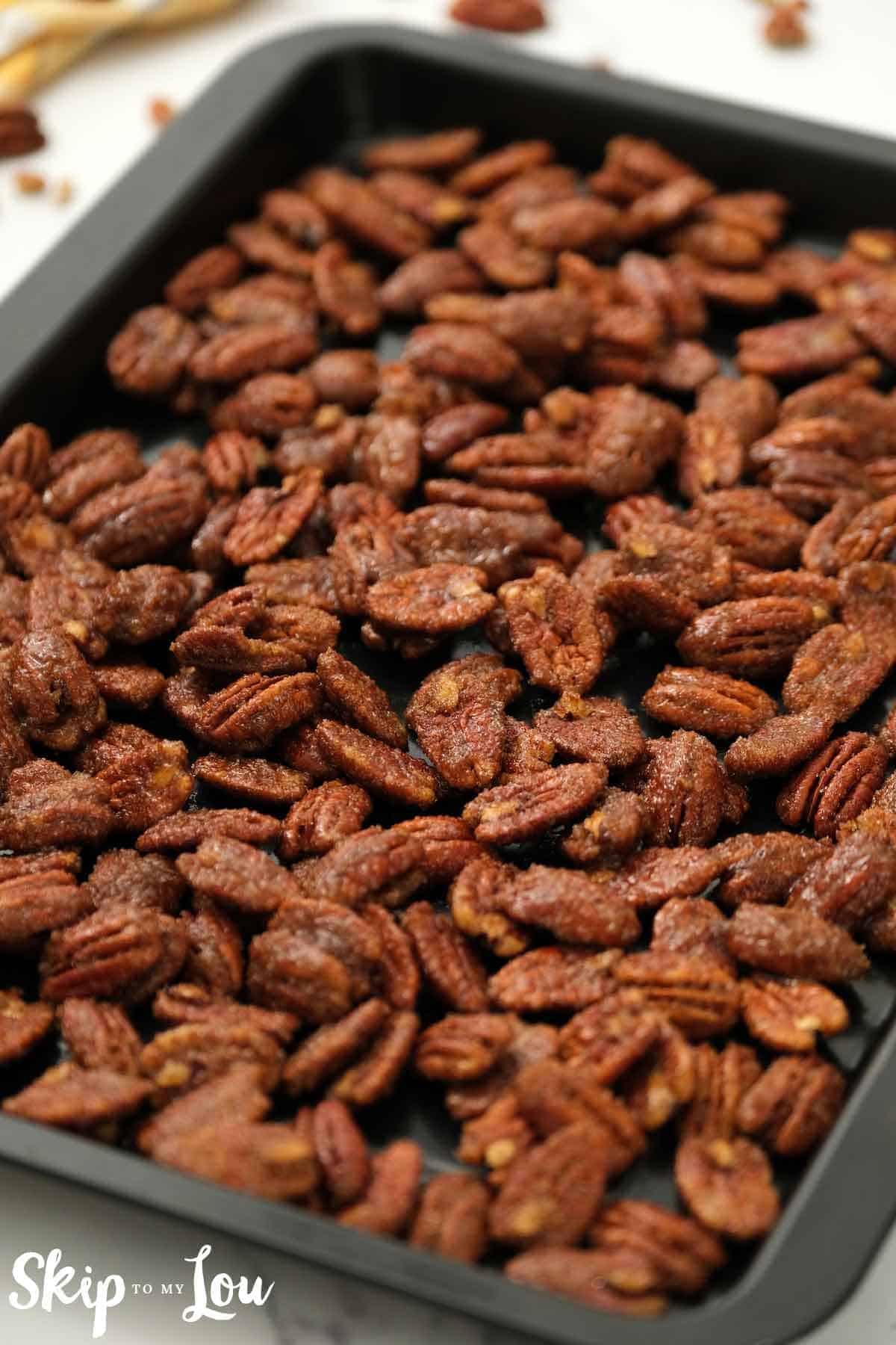 candied pecans on baking sheet