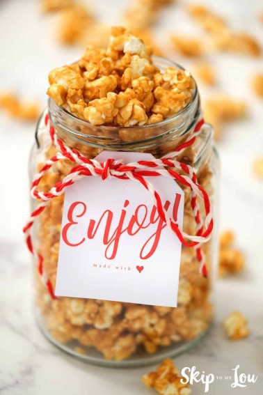 homemade caramel corn in glass jar with enjoy gift tag