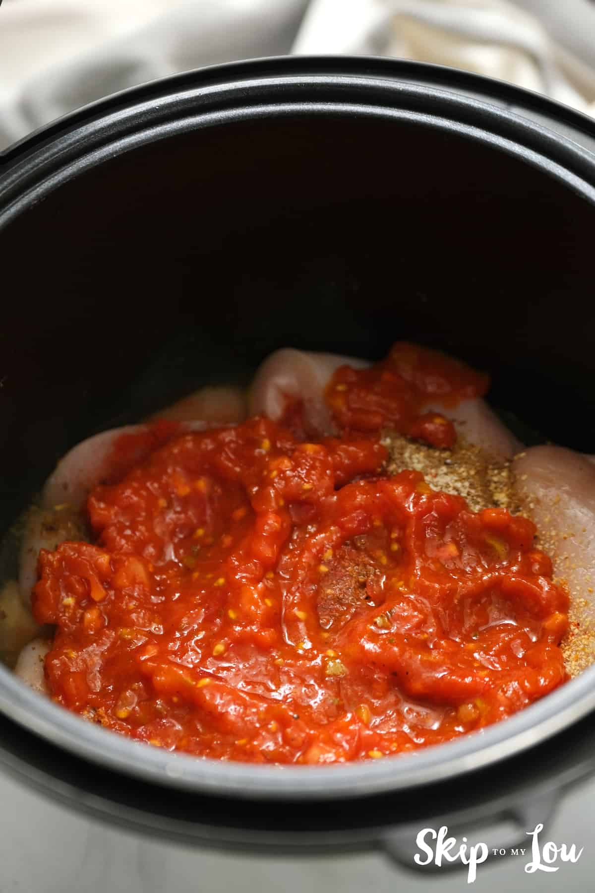 add salsa on top and prepare your instant pot for Salsa Chicken