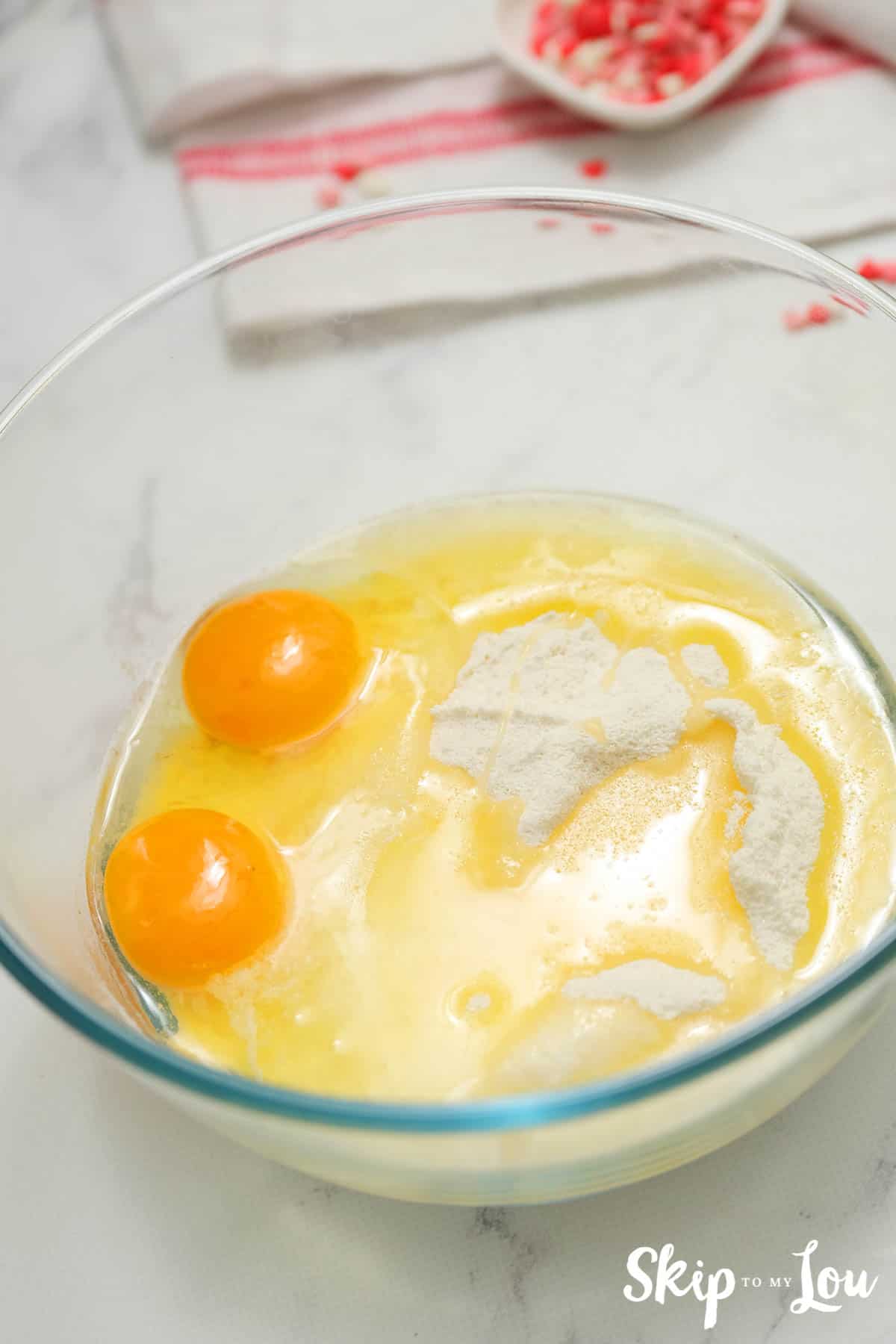 eggs cake mix and oil in clear glass mixing bowl