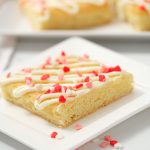 sugar cookies bars with sprinkles on white plate