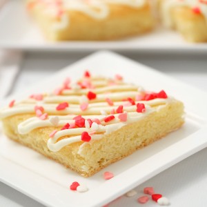 sugar cookies bars with sprinkles on white plate