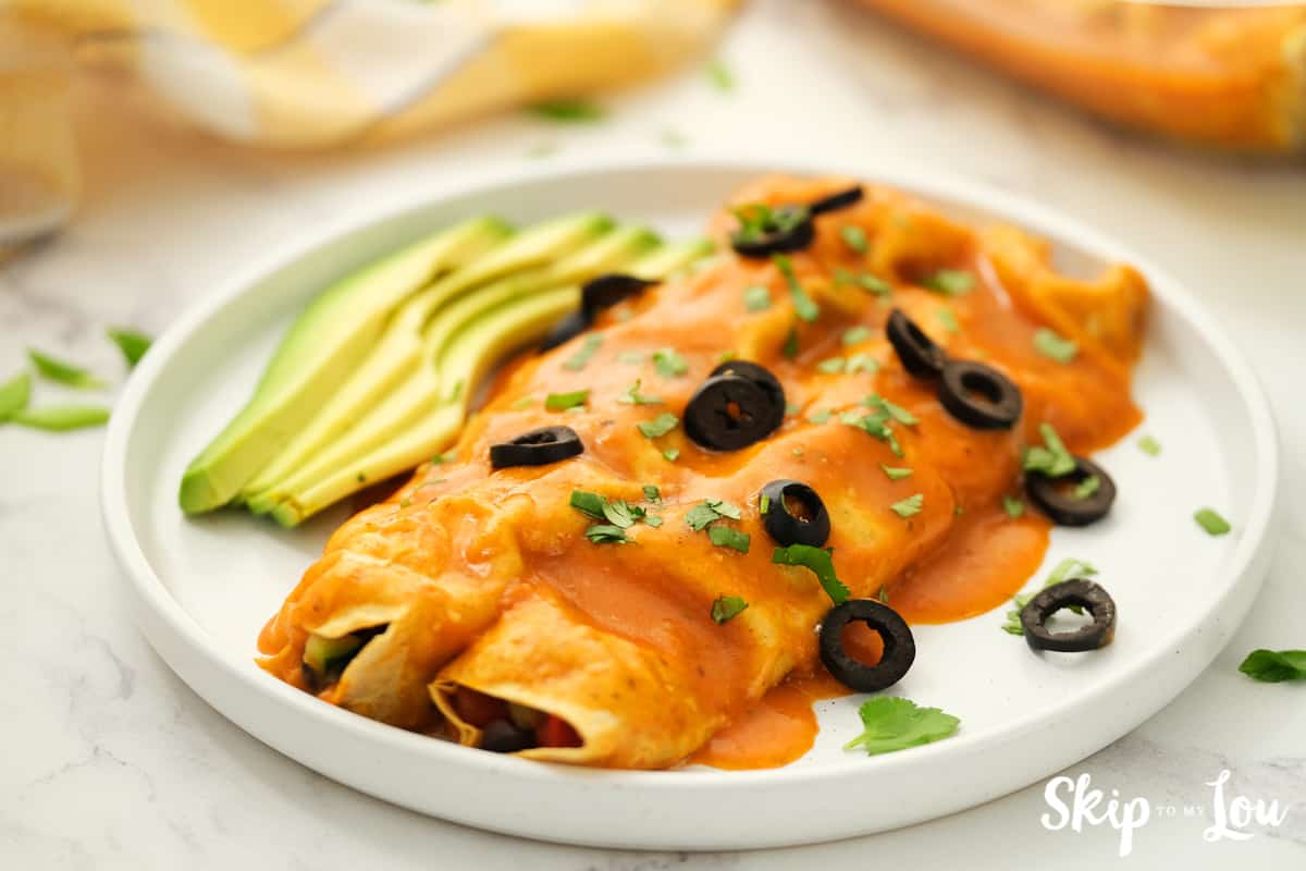 Best Dairy Free Vegan Enchiladas served with avocado slices and olives.
