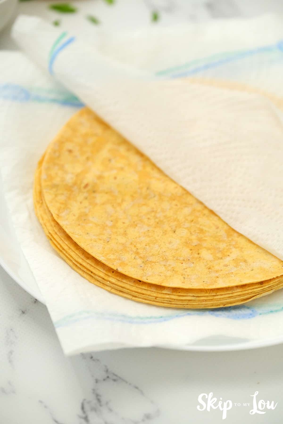 Next for you vegan enchiladas, Soften the corn tortillas by wrapping them in a damp paper towel and microwaving them for 10 seconds. Or they can be heated in a skillet.