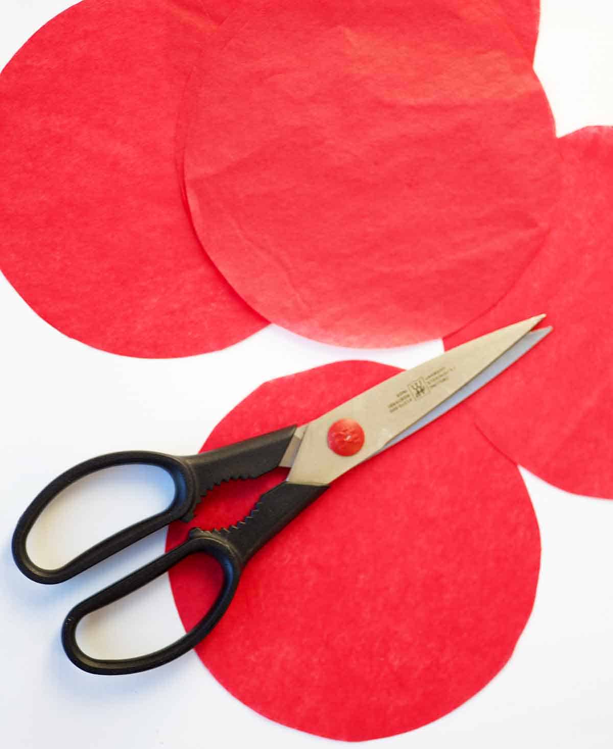 5 inch circles of red tissue paper with scissors