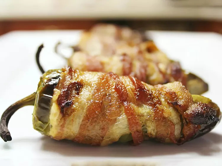 bacon wrapped peppers stuffed with cheese
