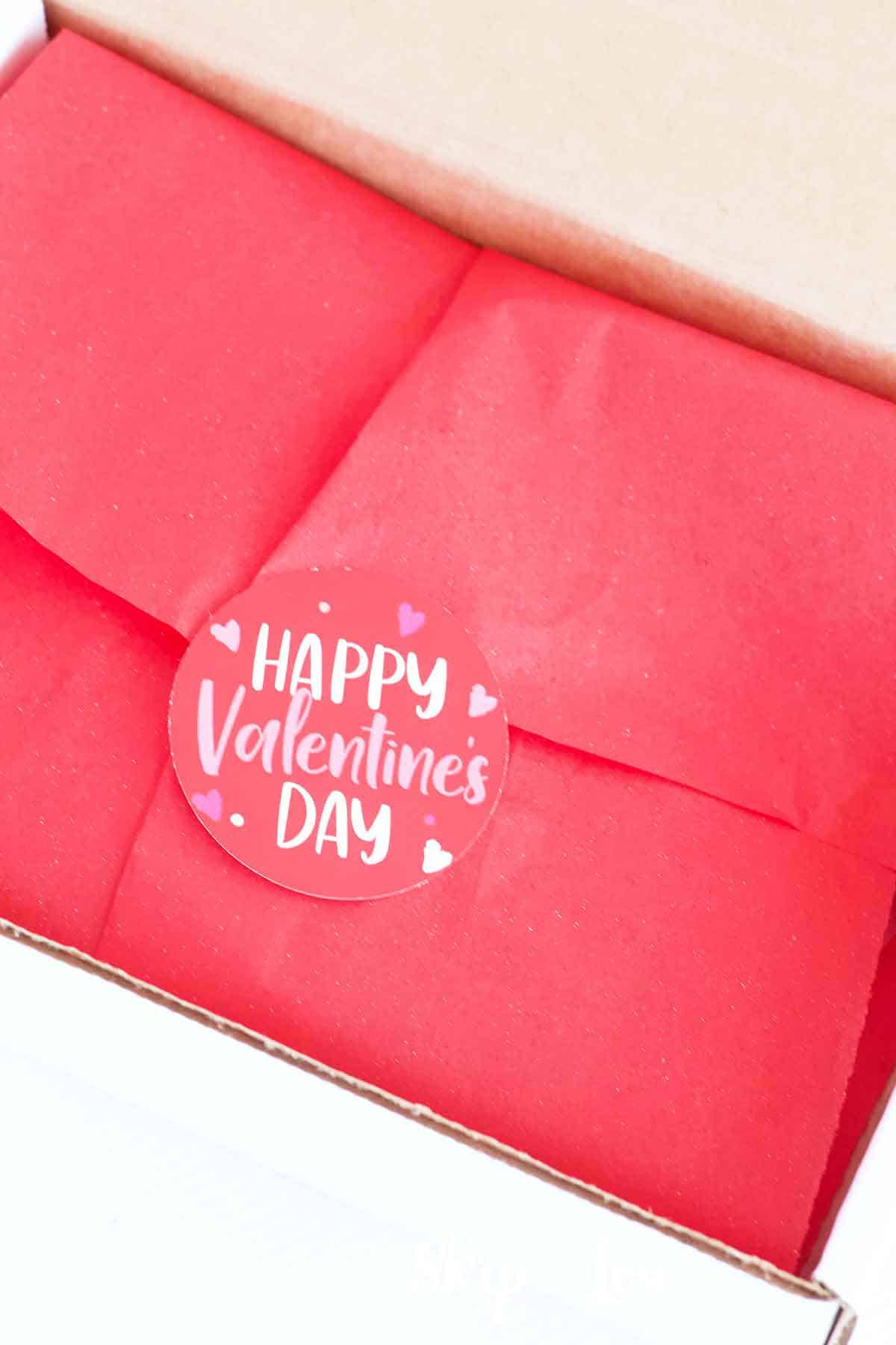red tissue folded and sealed with happy valentines day sticker