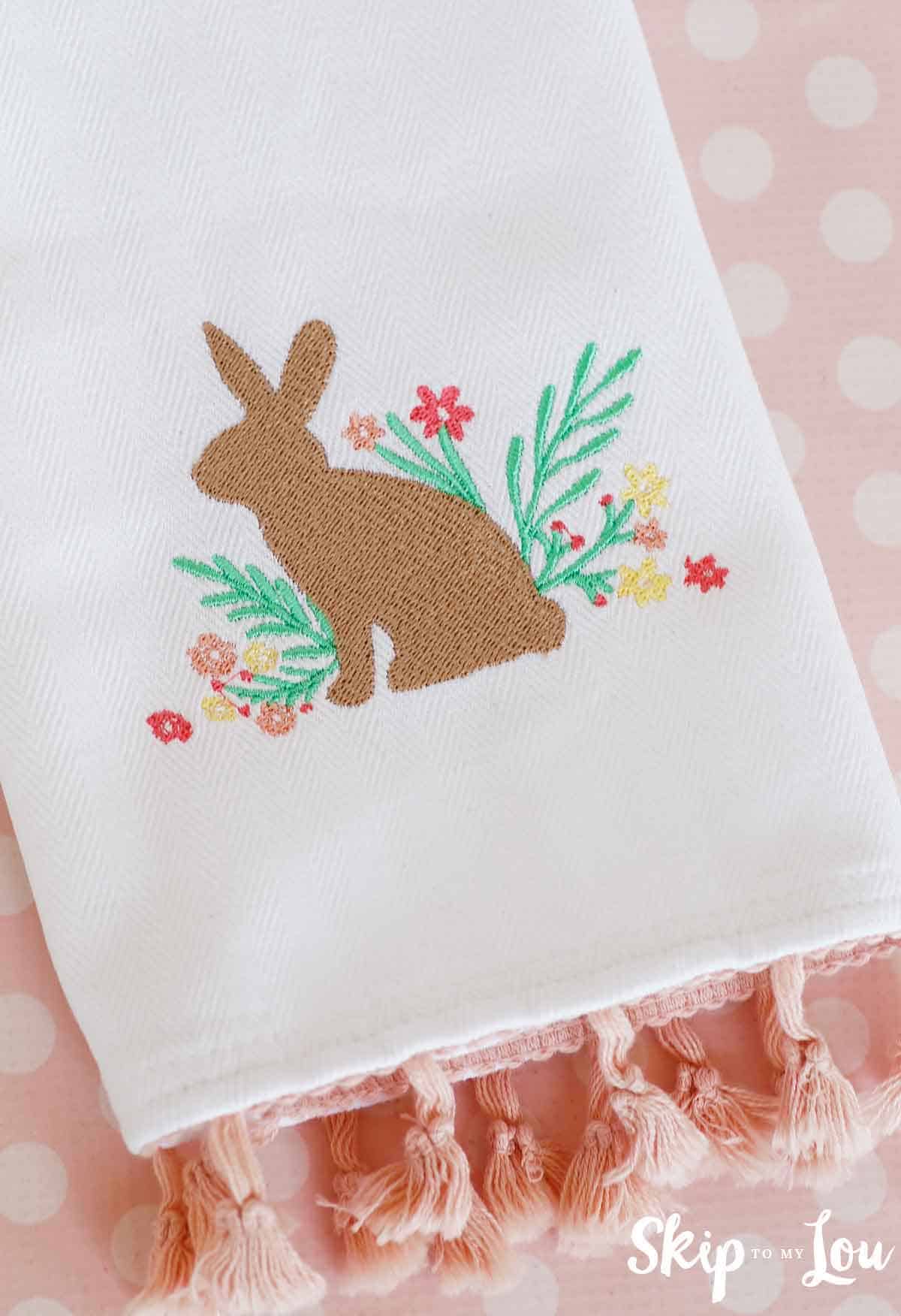 beautiful machine embroidered tea towel with brown bunny and floral flowers with pink trim