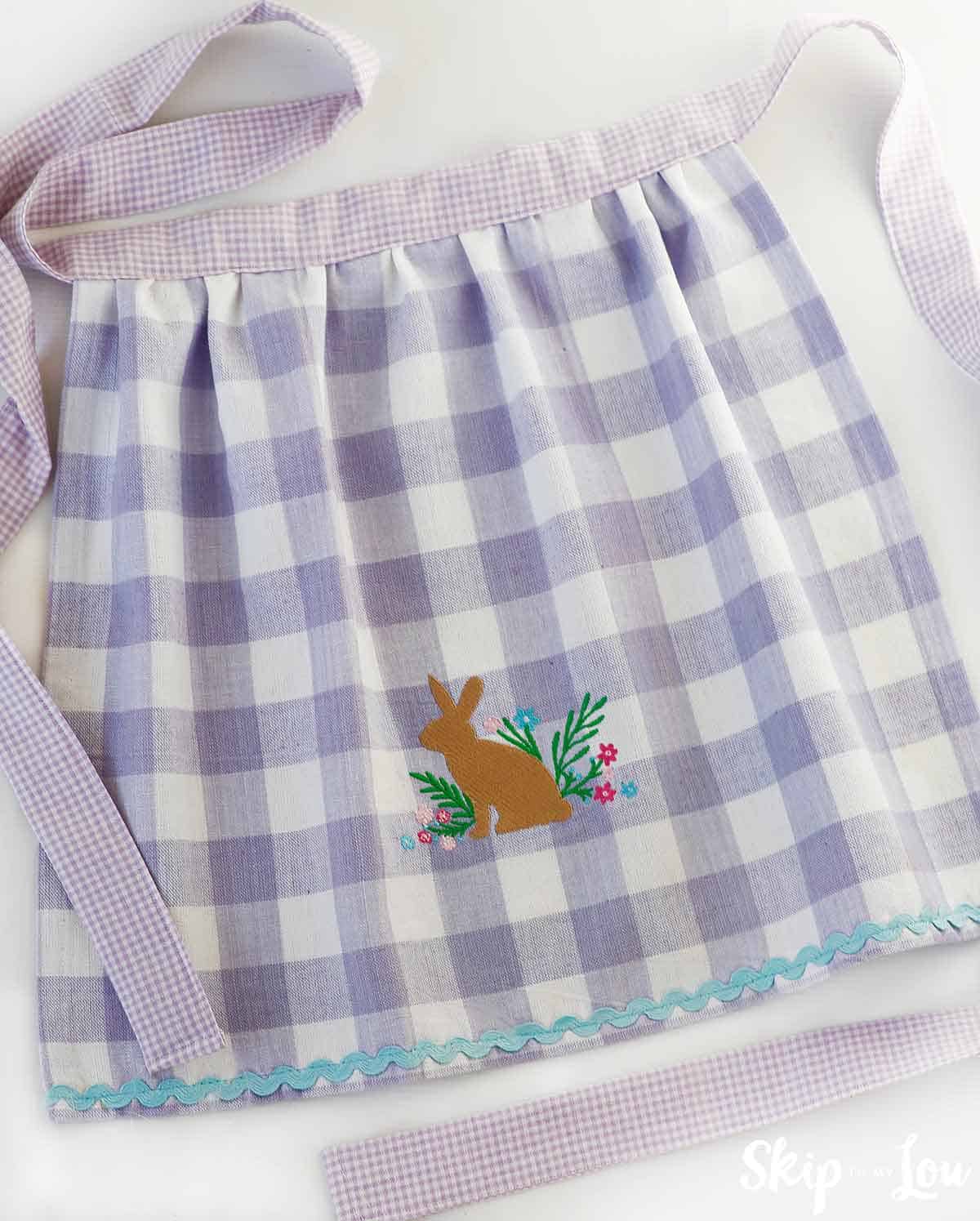 cute machine embroidered bunny with flowers on checkered purple apron