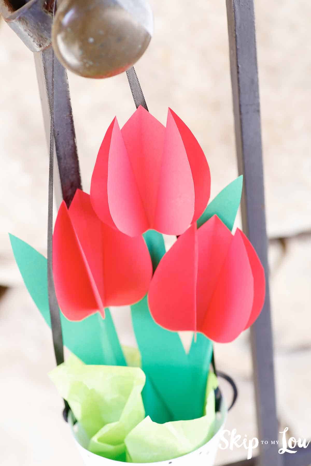 paper tulips in may basket hanging on gate