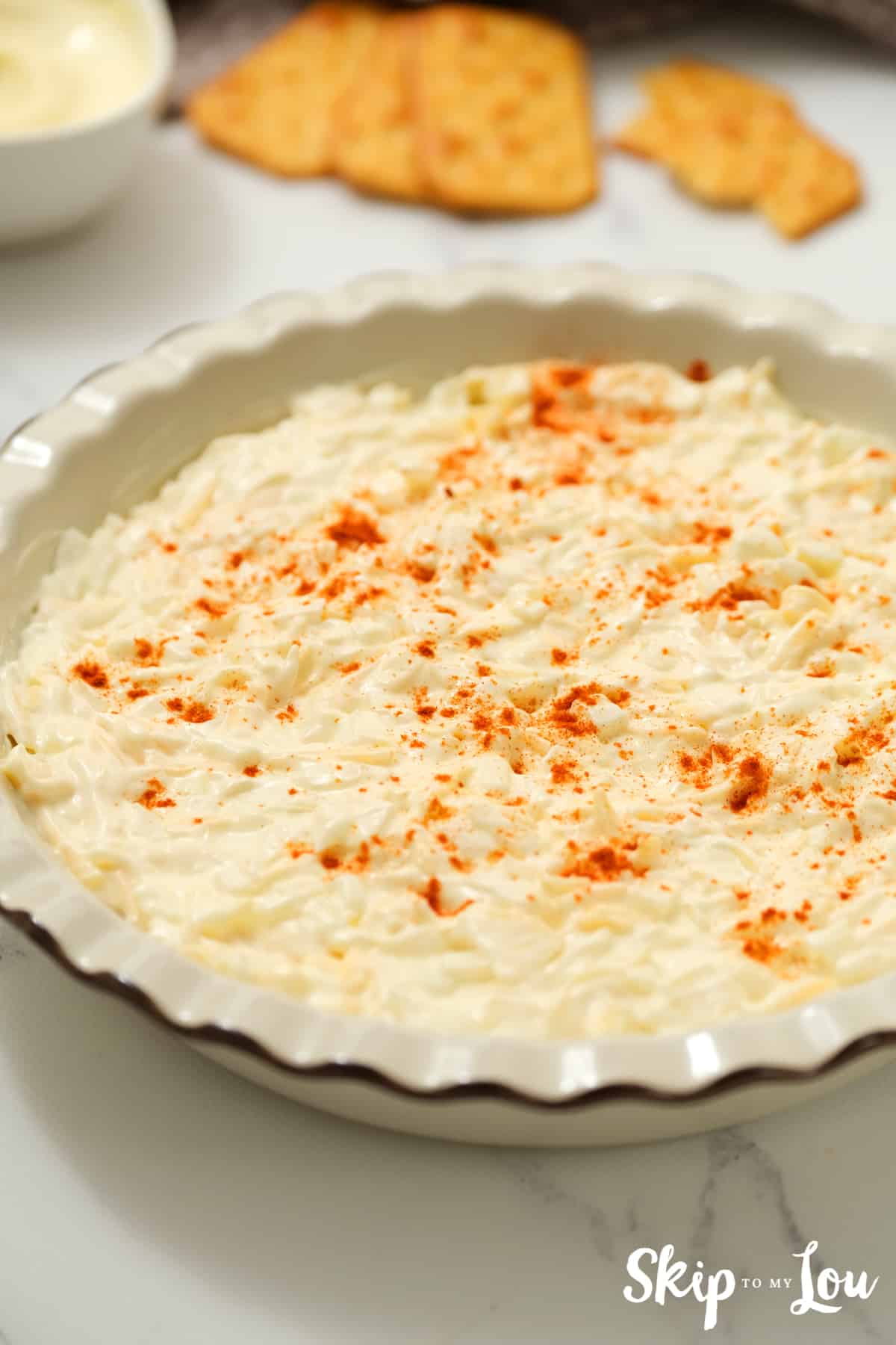 Put mixture in baking dish and sprinkle lightly with paprika and bake.