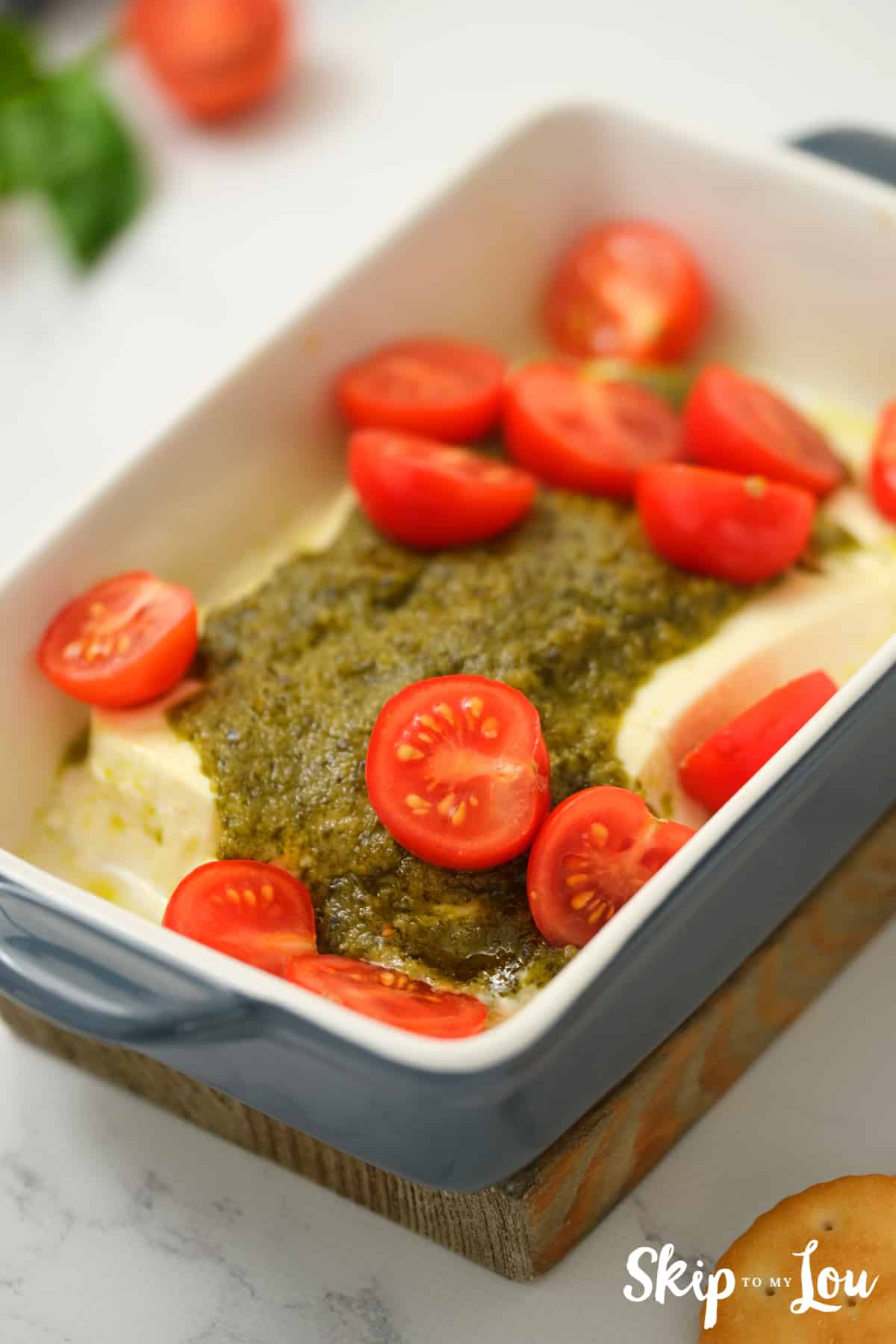 put tomatoes on top of hot spread