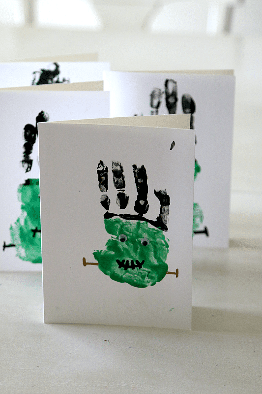 Green Frankenstein Halloween handprint craft on white card 