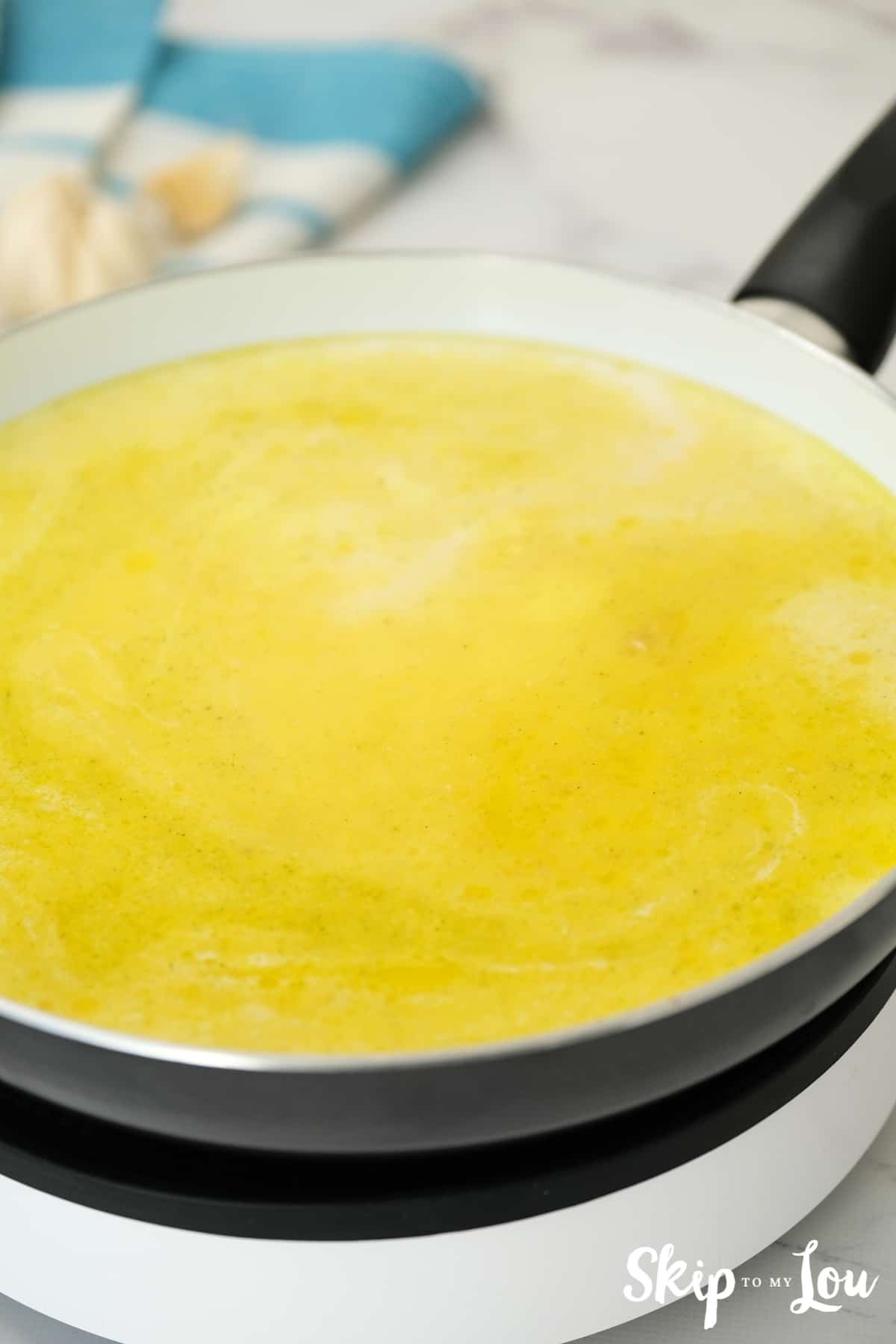 add in chicken broth for the one pot fettuccine alfredo