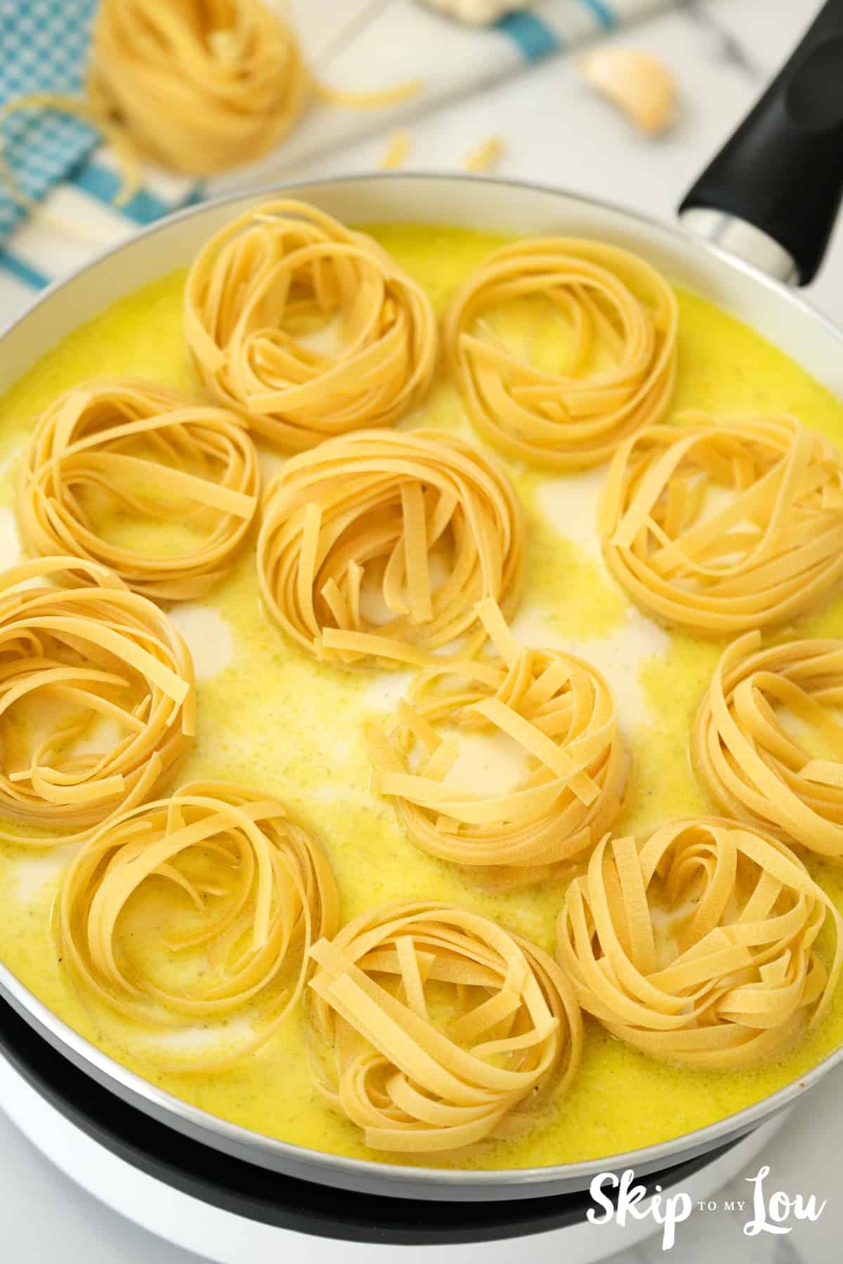 add the half and half, butter and uncooked noodles. 