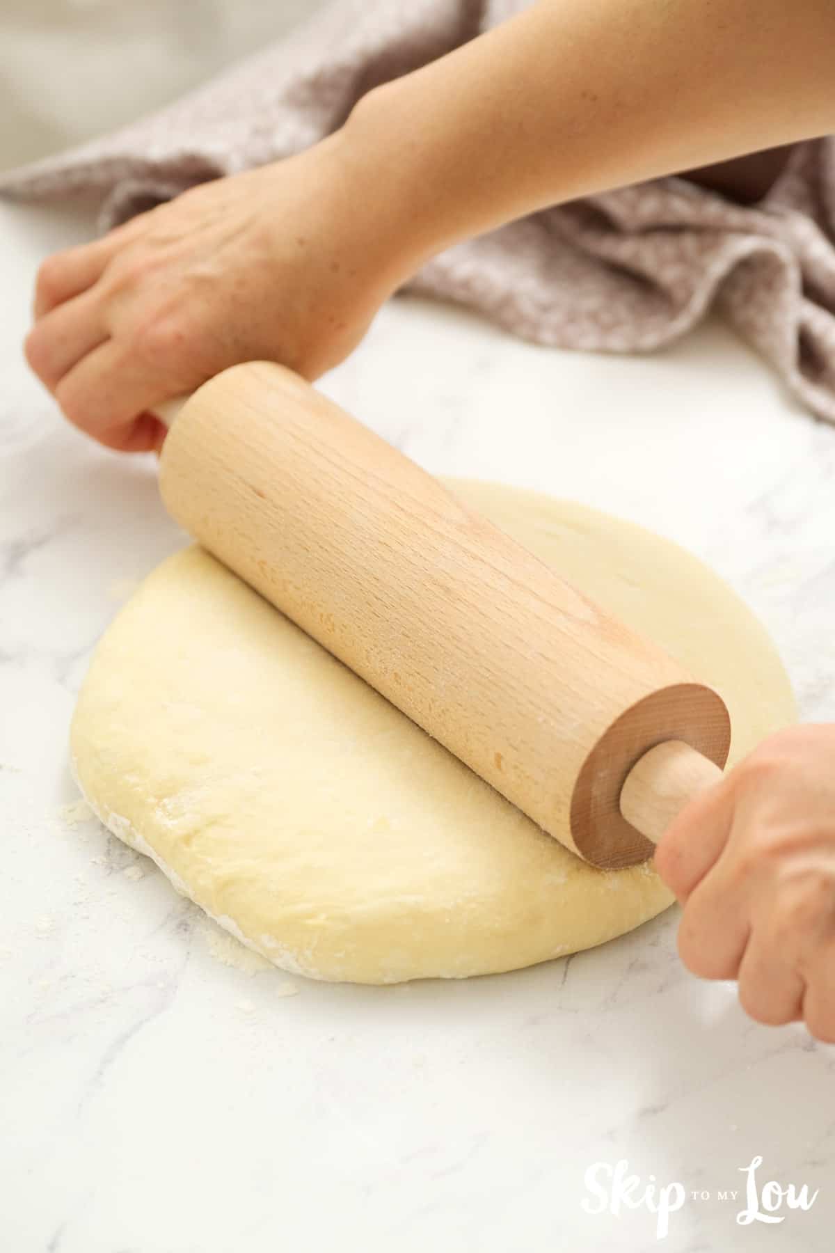roll out dough for your herb cheese rolls