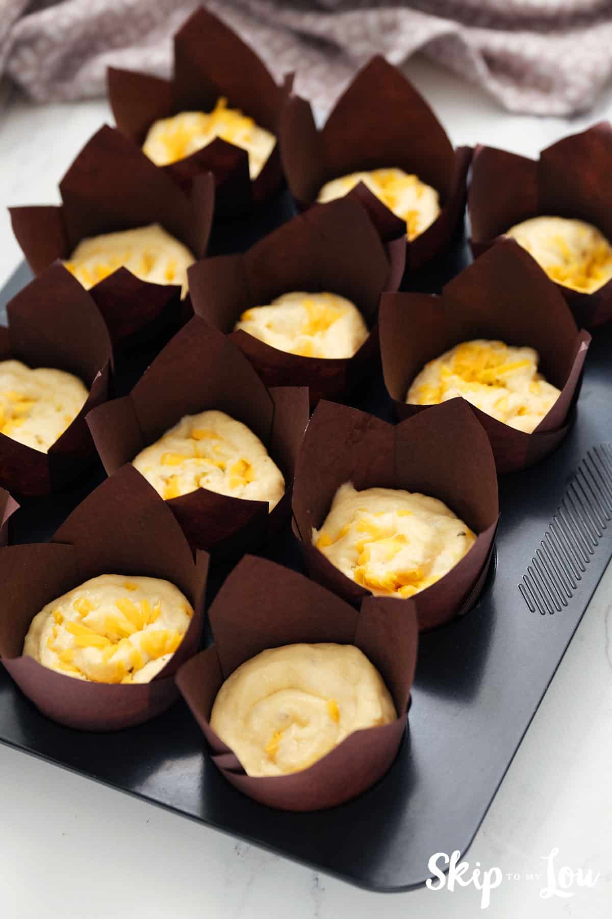 Line muffin tin with brown tulip baking cups and place individual rolls in each cup. Allow to rise about 45 minutes.