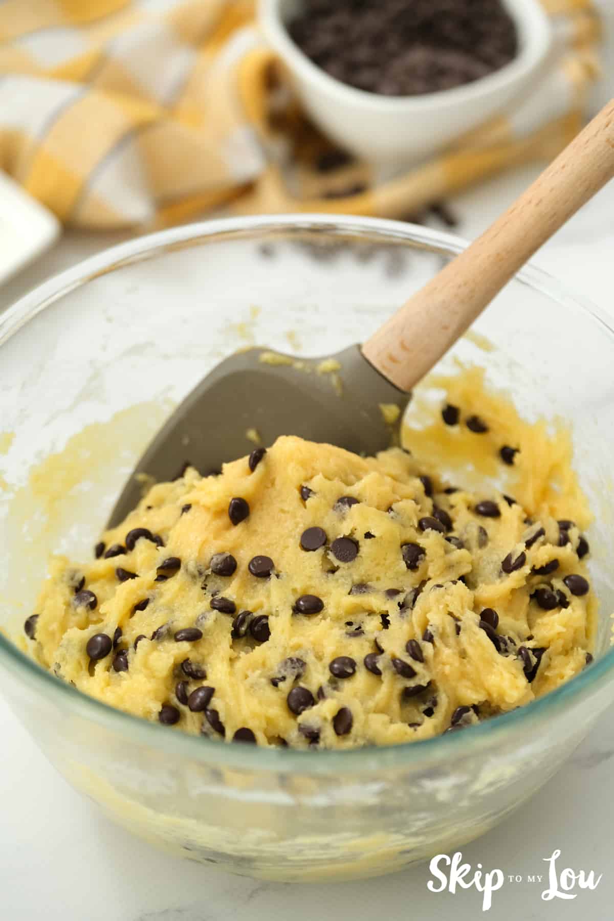 Stir batter with chocolate chips for the cake mix cookie bars.