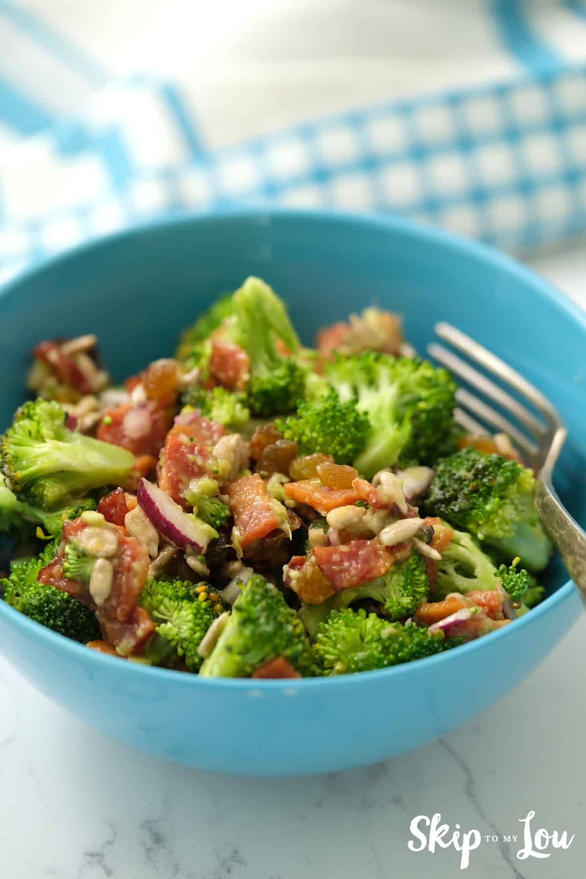sauce poured over the broccoli salad and served in a blue bowl
