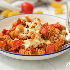 One Pot Pizza Pasta served in white dish with fork.