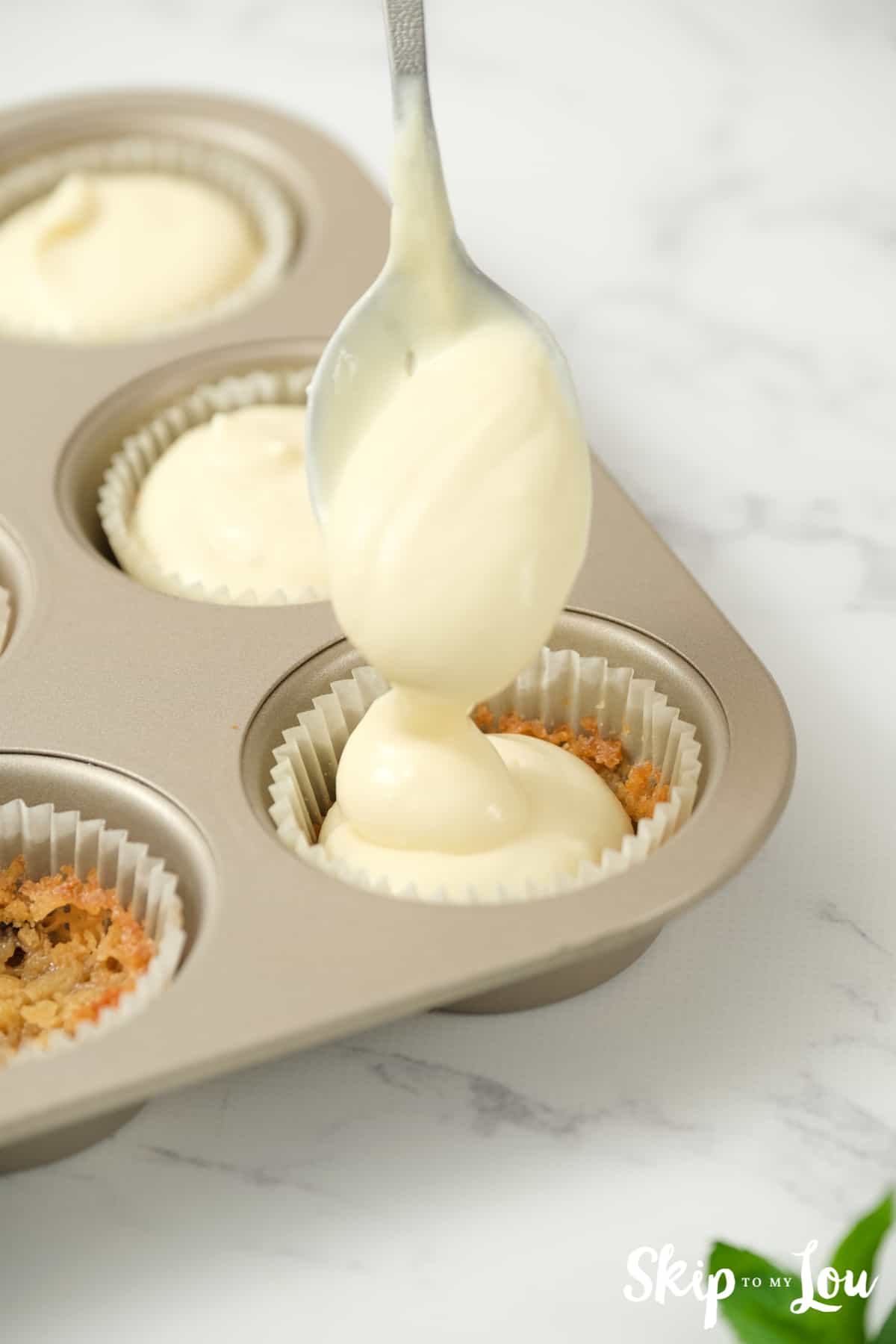 spoon cheesecake batter on top of cookie