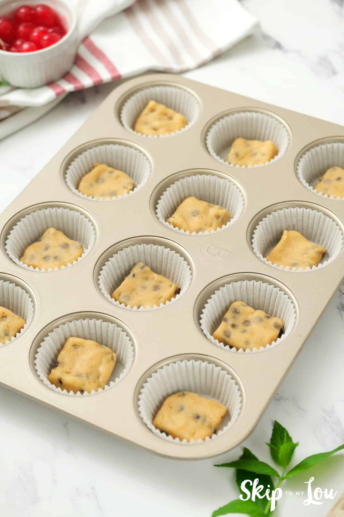 place cookie dough into lined muffin tin