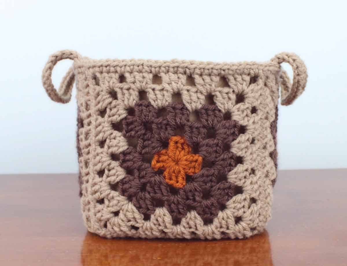 granny square basket in browns with an orange burst