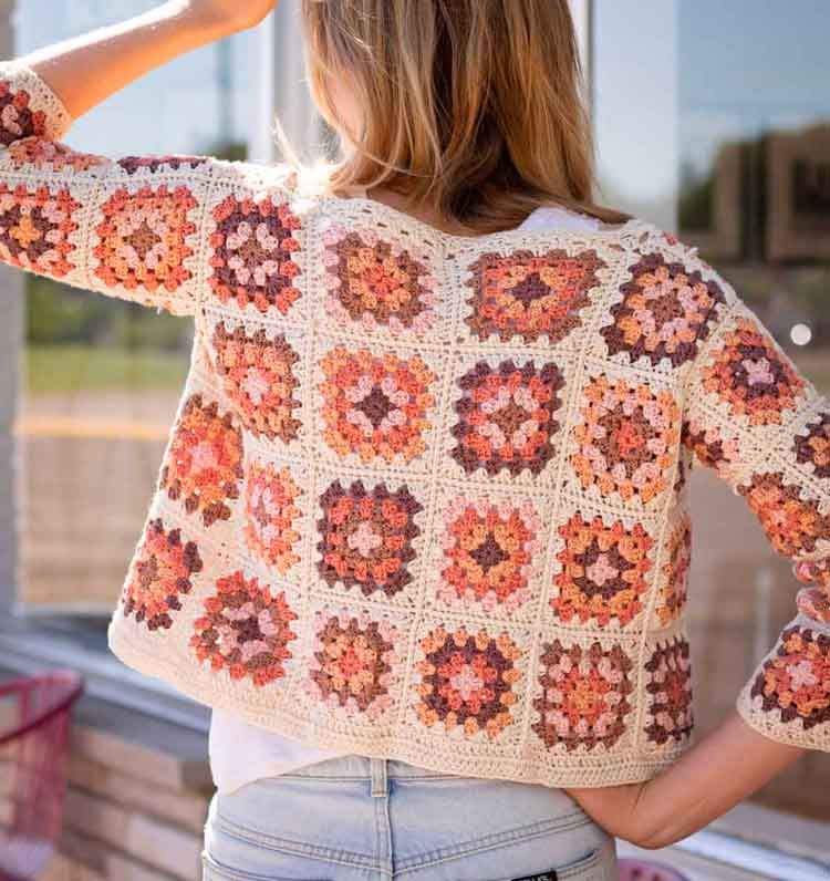 creative creams, pinks, and oranges were used to make this granny square cardigan sweater