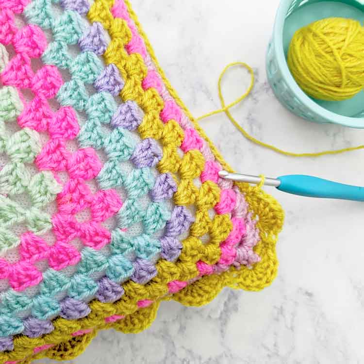 cushion cover being crocheted with a granny square