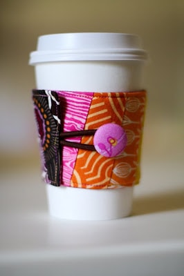 Cute fabric coffee sleeve shown on cup