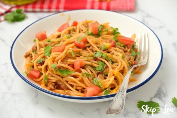 Mexican Spaghetti served on a white dish with a fork.