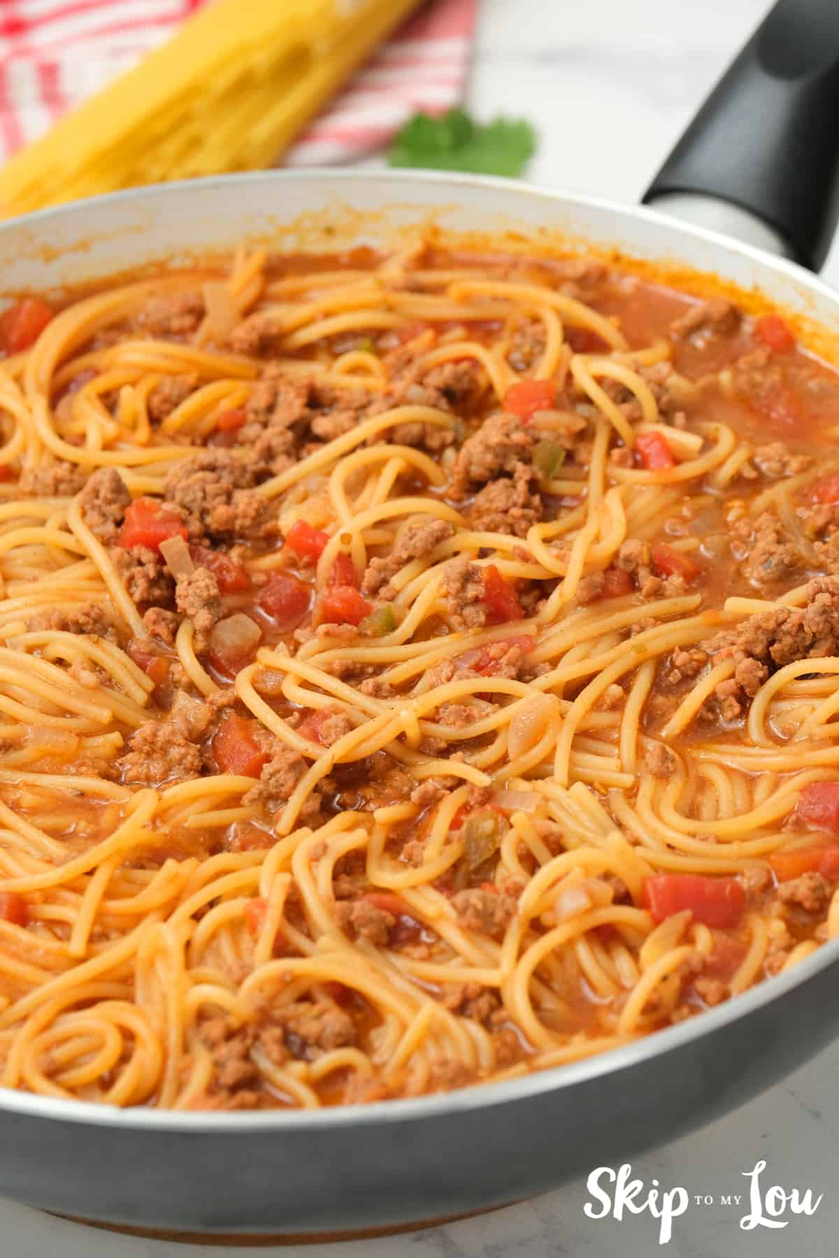 Mexican Spaghetti is cooked stir in half the cheese.