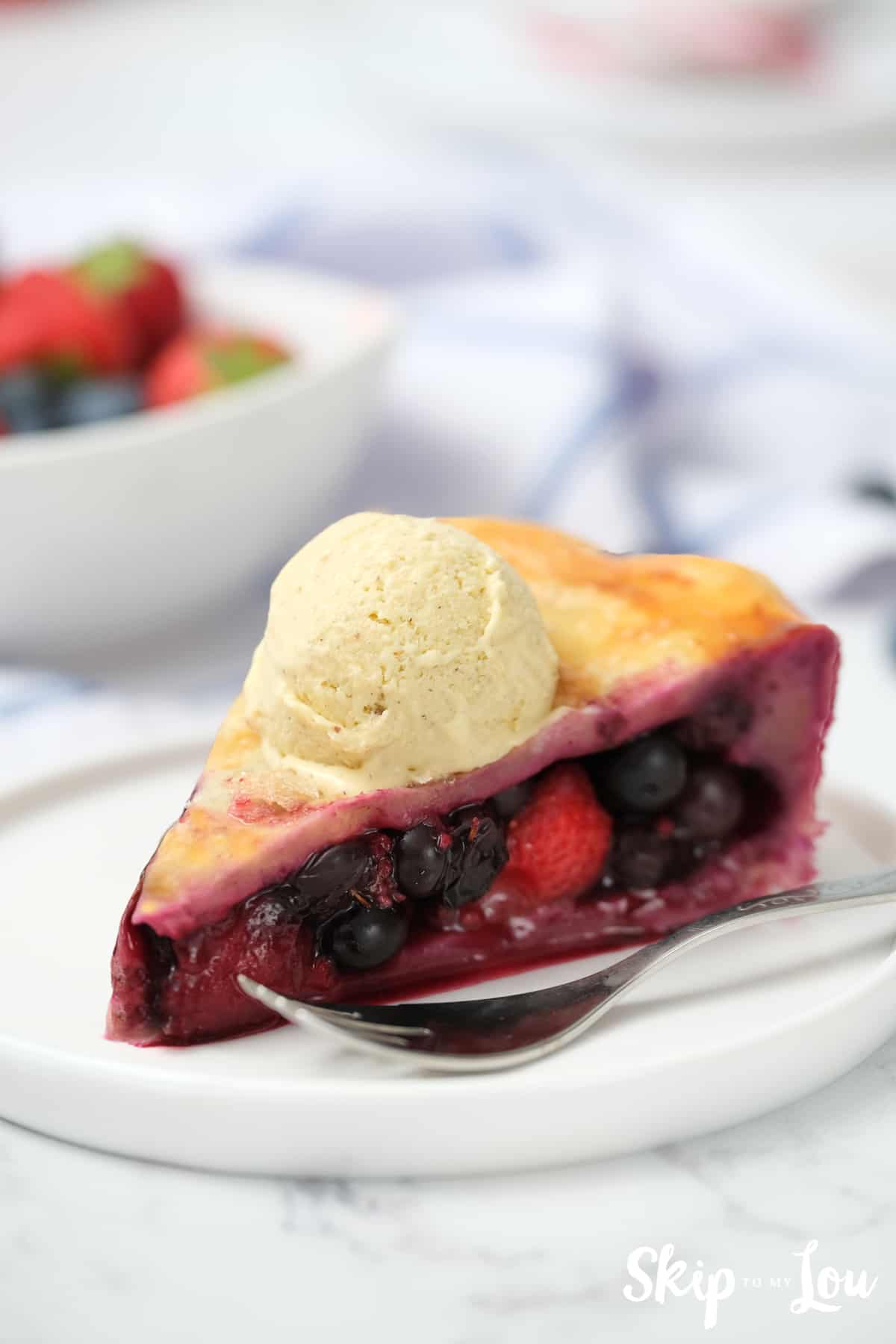Slice of Triple Berry Pie with Ice Cream.